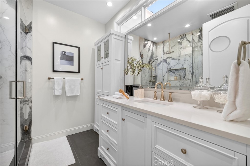 25714 Simpson Place Calabasas, CA 91302 - Photo 29 of 44 a bathroom with a sink a mirror and a shower