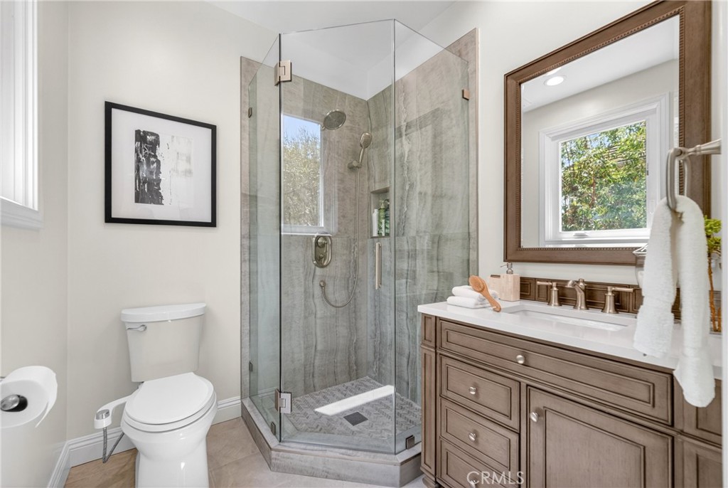 25714 Simpson Place Calabasas, CA 91302 - Photo 32 of 44 a bathroom with a toilet sink and shower