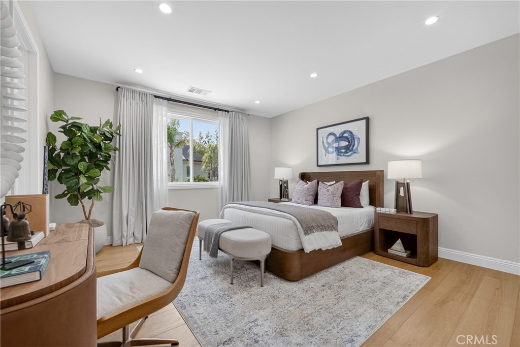 25714 Simpson Place Calabasas, CA 91302 - Photo 33 of 44 a spacious bedroom with a bed and a couch