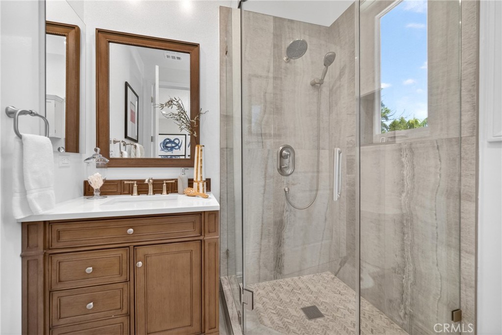 25714 Simpson Place Calabasas, CA 91302 - Photo 34 of 44 a bathroom with a shower sink and mirror