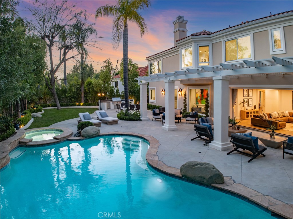 25714 Simpson Place Calabasas, CA 91302 - Photo 41 of 44 a front view of a house with swimming pool table and chairs