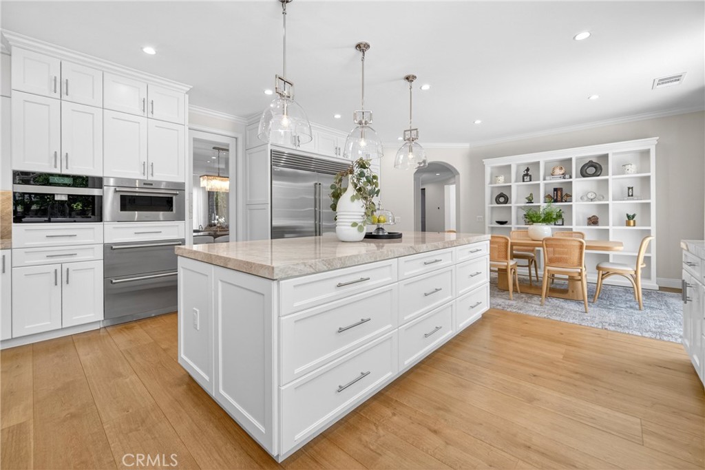 25714 Simpson Place Calabasas, CA 91302 - Photo 10 of 44 a kitchen with stainless steel appliances granite countertop a stove and a wooden floors