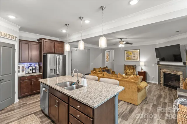 a kitchen with sink refrigerator and stove
