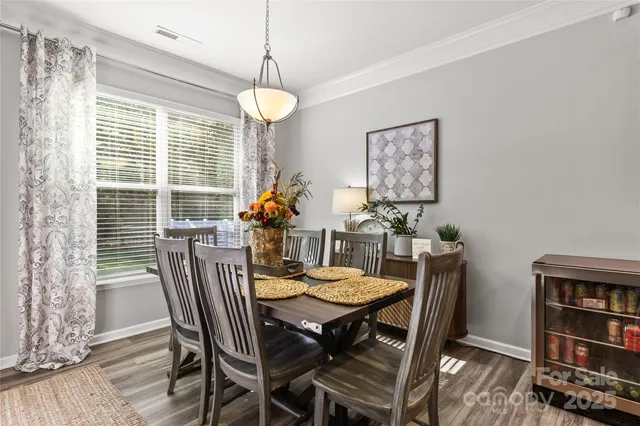 a view of a dining room with furniture and a book shelf