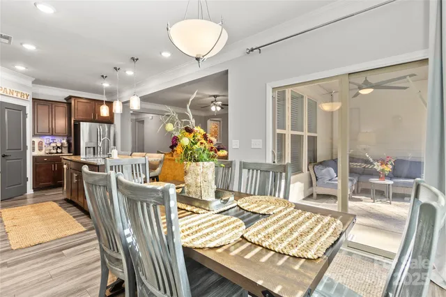 a view of a dining room with furniture a chandelier and wooden floor