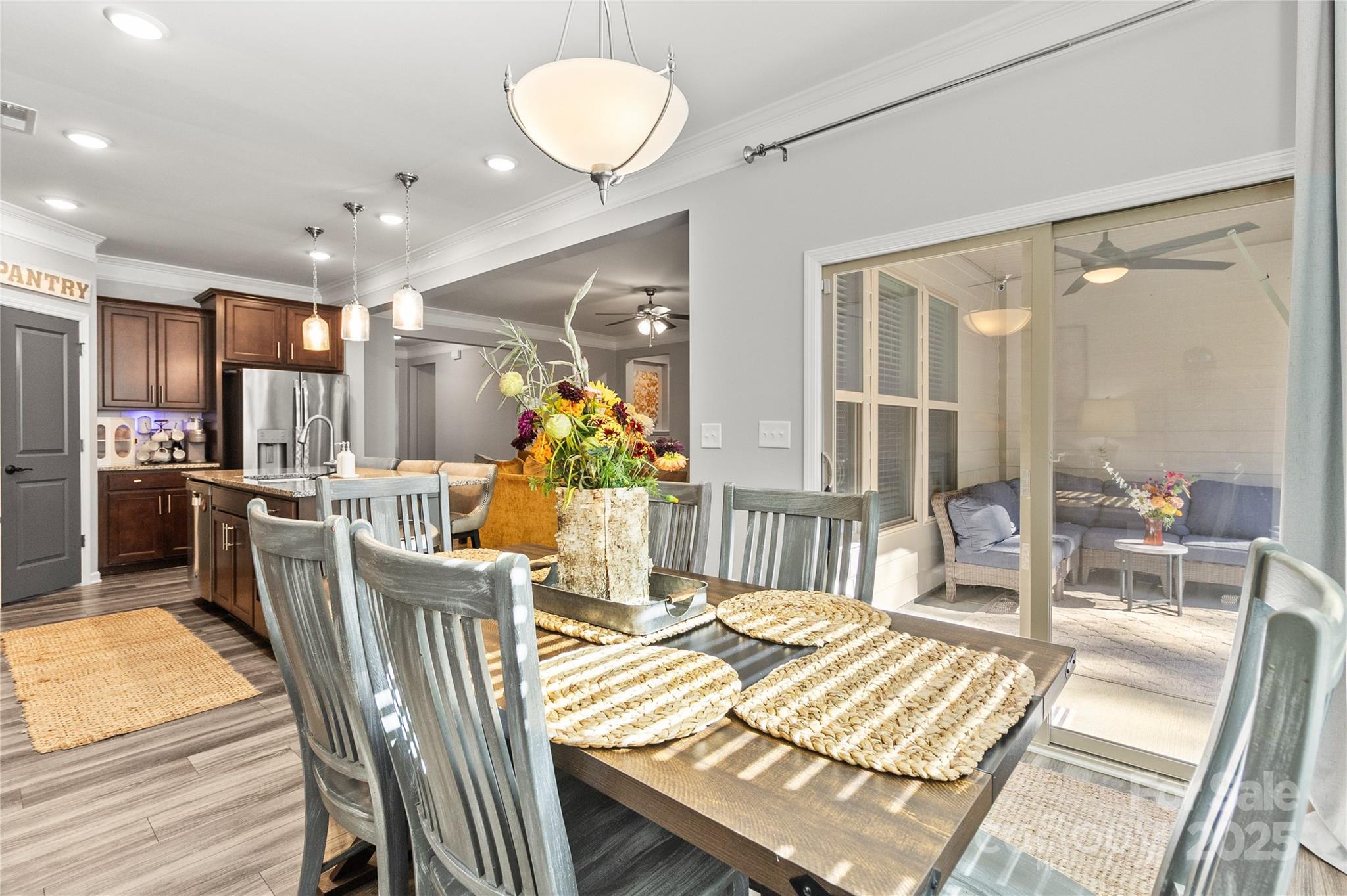 5169 Devonshire Road Denver, NC 28037 - Photo 13 of 46 a view of a dining room with furniture a chandelier and wooden floor