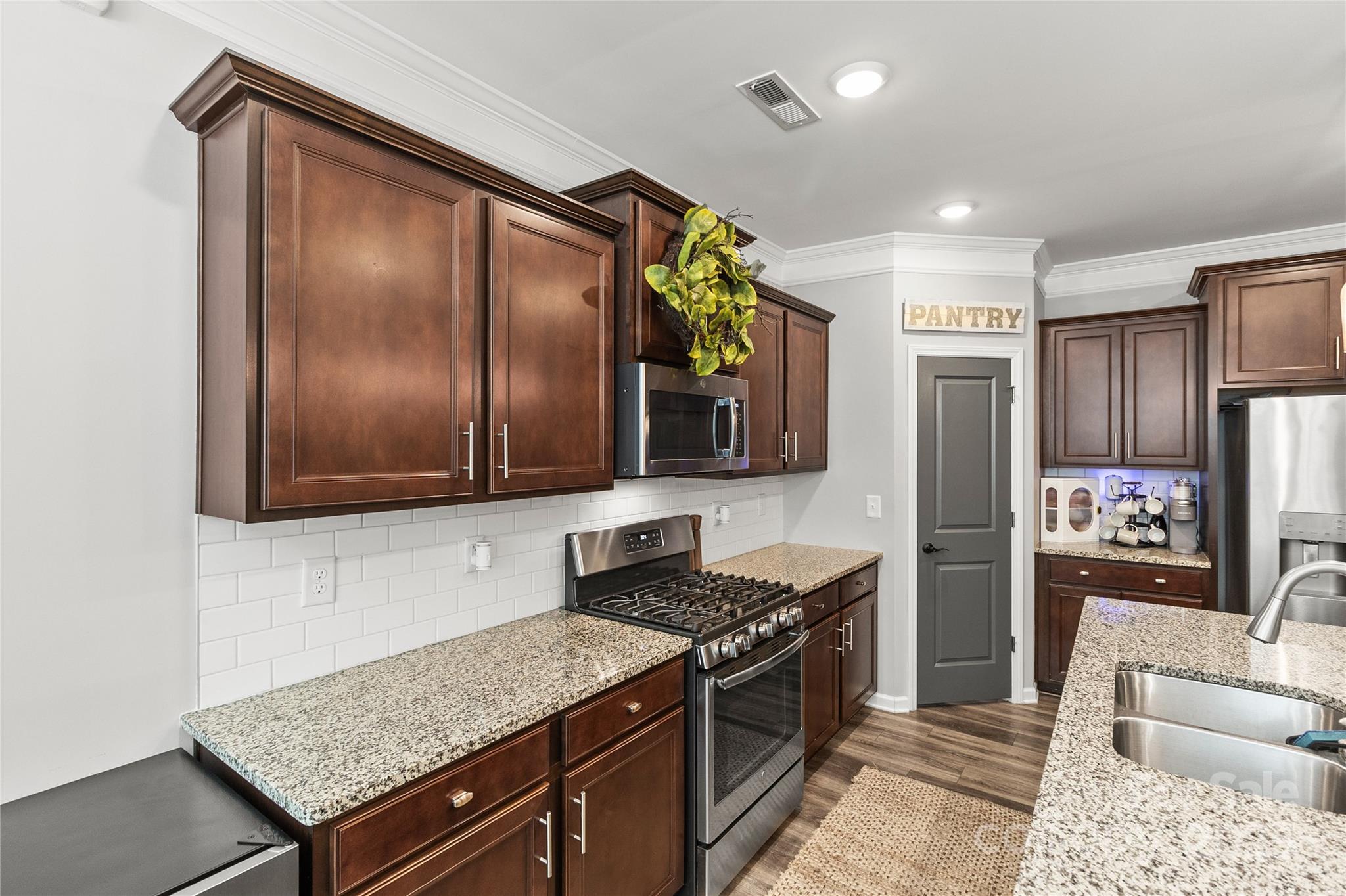 5169 Devonshire Road Denver, NC 28037 - Photo 15 of 46 a kitchen with stainless steel appliances granite countertop a refrigerator and a stove top oven