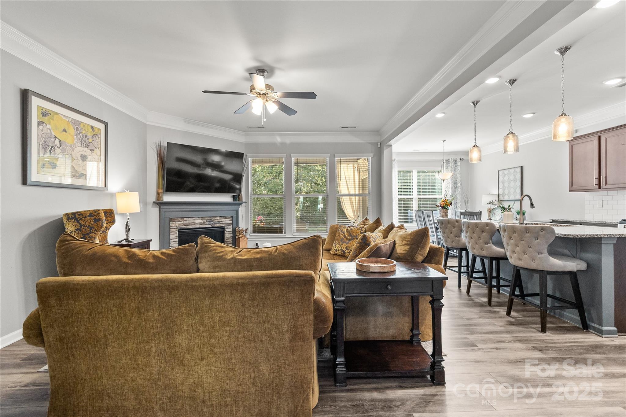 5169 Devonshire Road Denver, NC 28037 - Photo 16 of 46 a living room with furniture a dining table and a flat screen tv