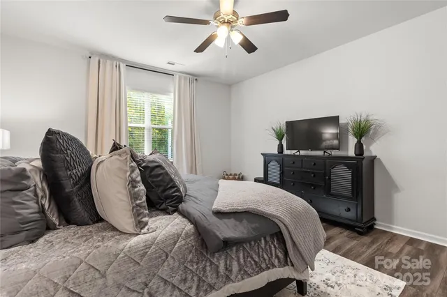 a bedroom with a bed and a television