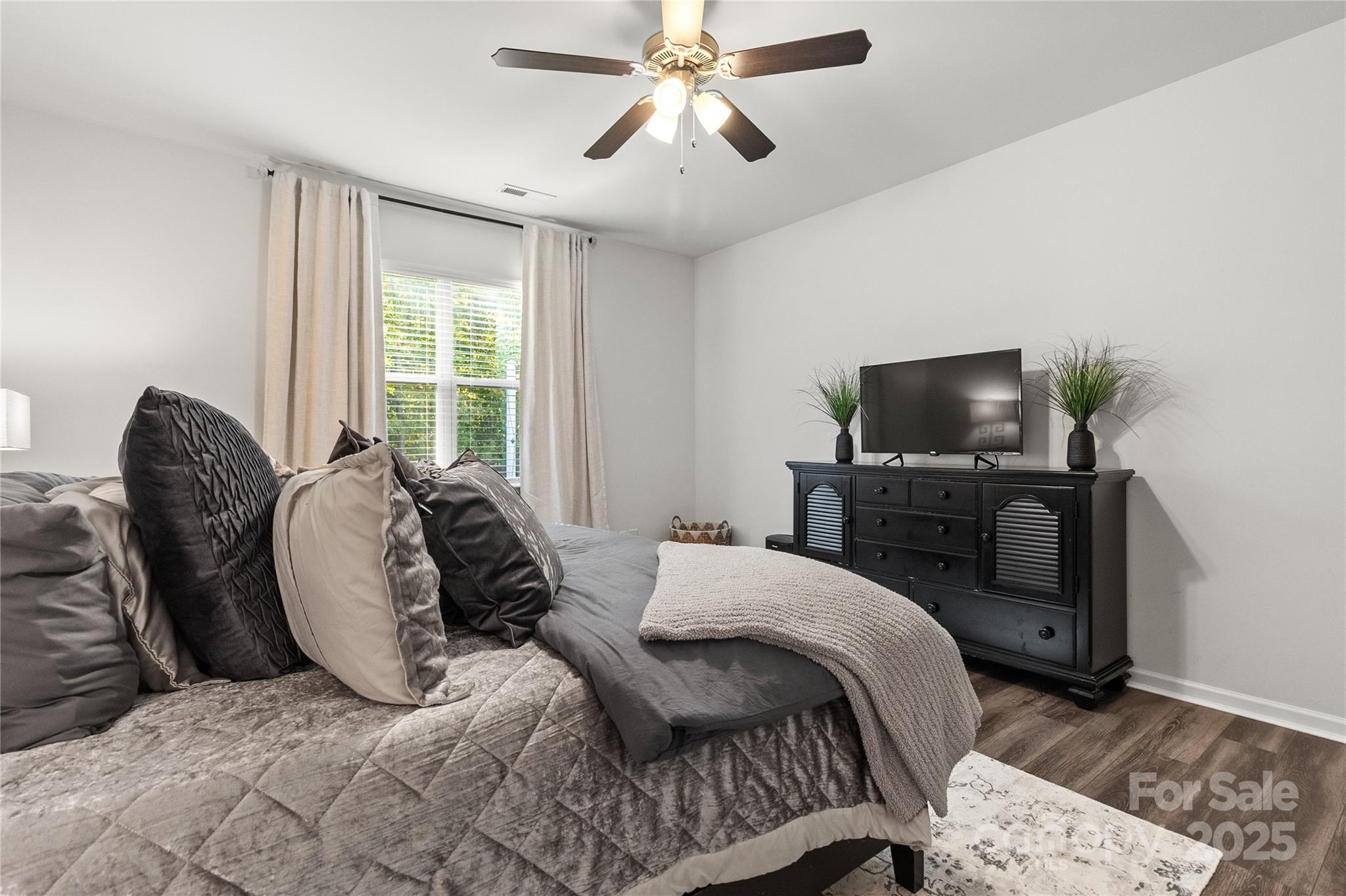 5169 Devonshire Road Denver, NC 28037 - Photo 19 of 46 a bedroom with a bed and a flat screen tv