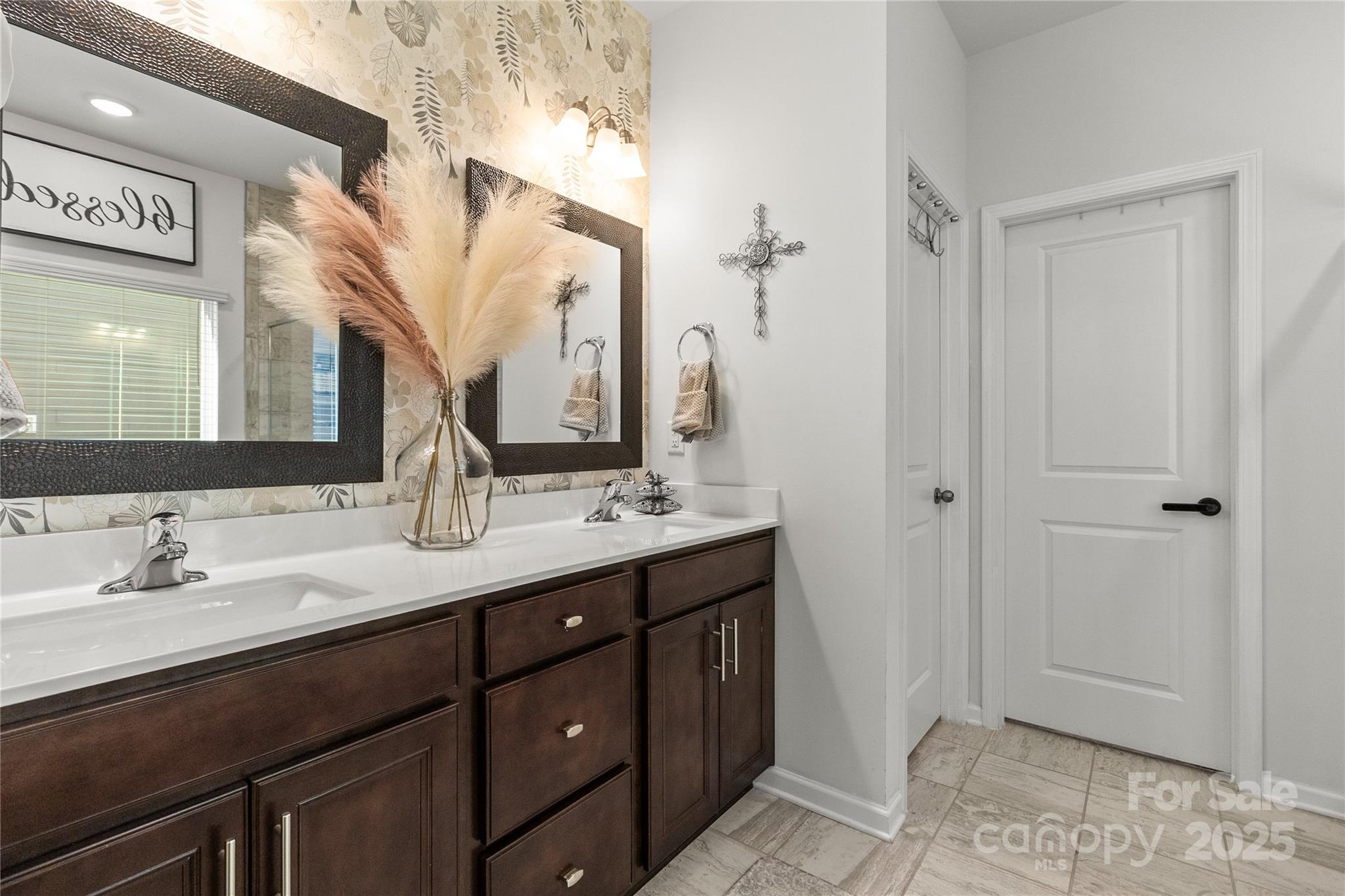 5169 Devonshire Road Denver, NC 28037 - Photo 21 of 46 a bathroom with a double vanity sink and a mirror