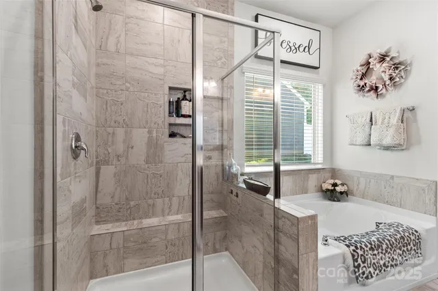 a bath room with a bath tub and a shower