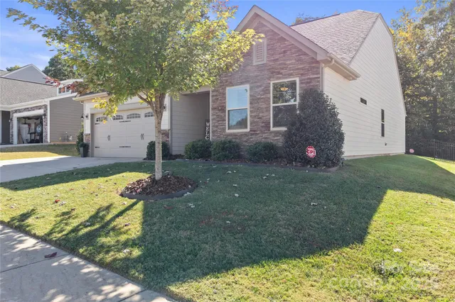 a aerial view of a house with swimming pool garden and patio