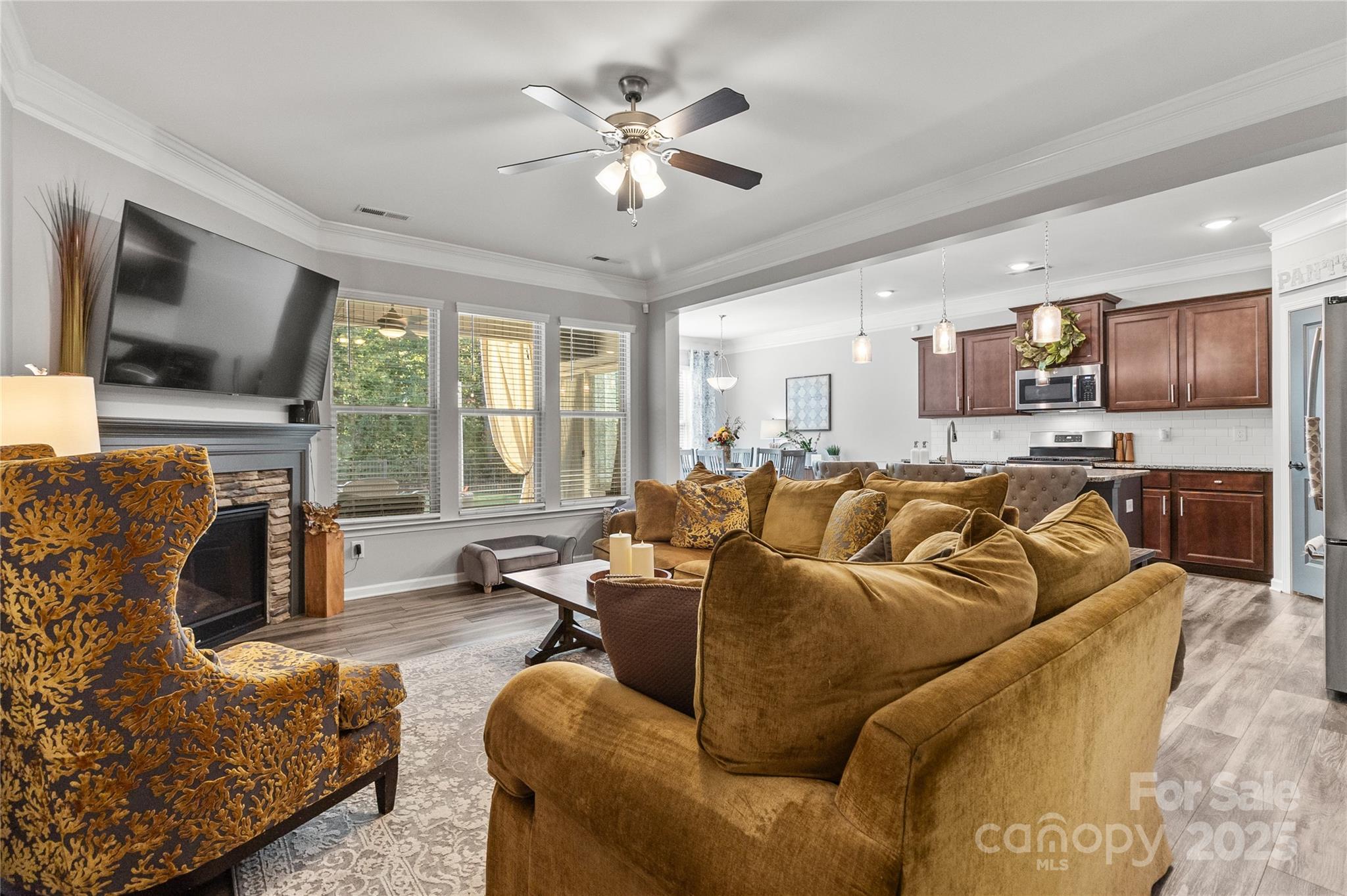 5169 Devonshire Road Denver, NC 28037 - Photo 7 of 46 a living room with furniture ceiling fan and a flat screen tv