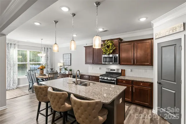 a kitchen with granite countertop lots of counter top space and stainless steel appliances