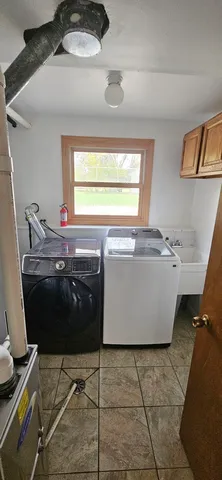 a room with a washing machine and a sink
