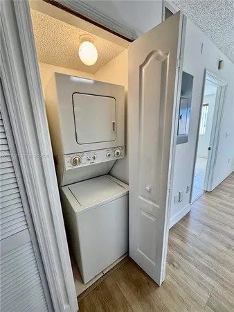an empty room with a window and a ceiling fan