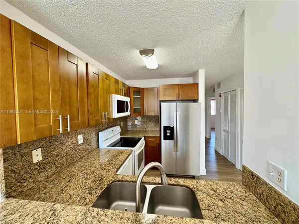 a kitchen with a stove microwave and sink
