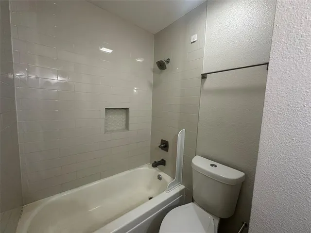 a bathroom with a toilet and a bathtub