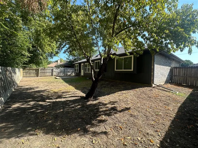 a view of a backyard of the house