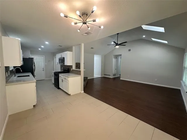 a view of a kitchen with furniture and a ceiling fan
