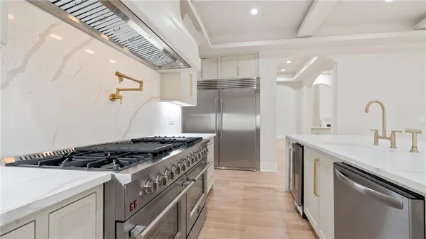 a kitchen with stainless steel appliances granite countertop a sink stove and refrigerator