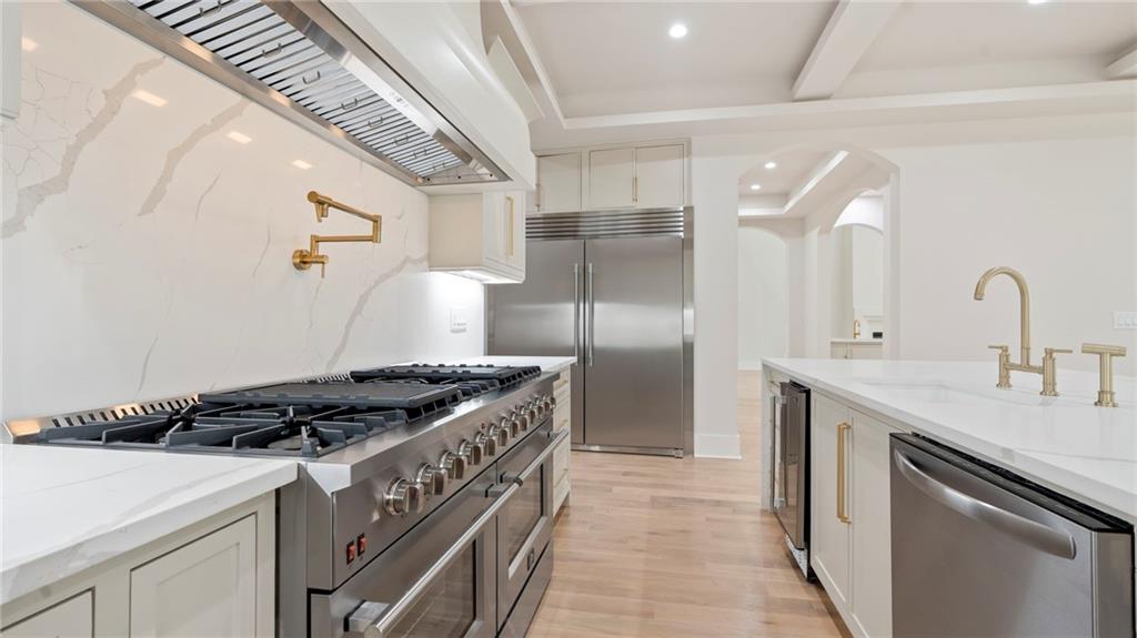 1694 Harts Mill Road Northeast Brookhaven, GA 30319 - Photo 13 of 44 a kitchen with stainless steel appliances granite countertop a sink stove and refrigerator