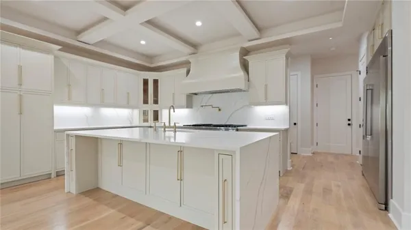 a kitchen with stainless steel appliances granite countertop a sink and a refrigerator