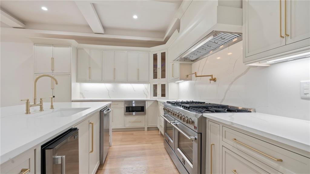 1694 Harts Mill Road Northeast Brookhaven, GA 30319 - Photo 15 of 44 a kitchen with stainless steel appliances granite countertop a sink stove and cabinets