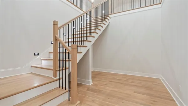 a view of entryway and hall with wooden floor