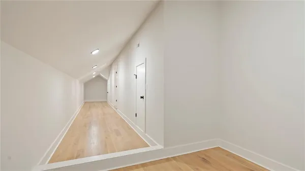 a view of a hallway with wooden floor