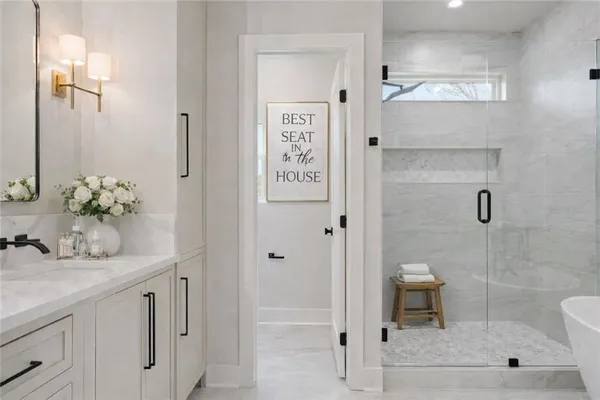 a bathroom with a shower sink and mirror