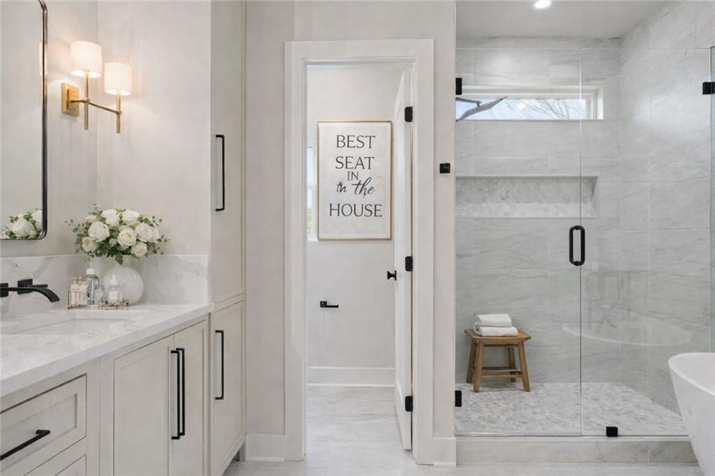 1694 Harts Mill Road Northeast Brookhaven, GA 30319 - Photo 26 of 44 a bathroom with a shower sink and mirror