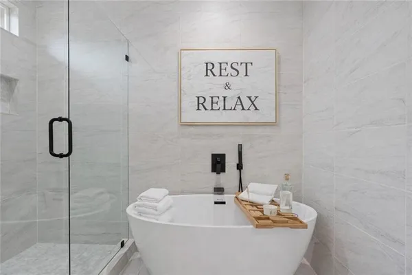 a bathroom with a bathtub and a shower