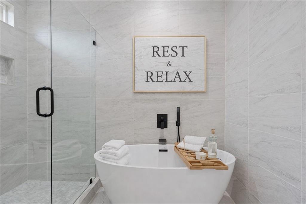 1694 Harts Mill Road Northeast Brookhaven, GA 30319 - Photo 27 of 44 a bathroom with a bathtub and a shower