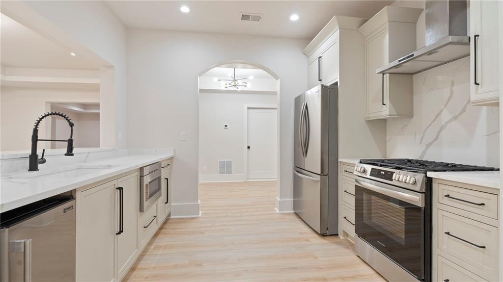 1694 Harts Mill Road Northeast Brookhaven, GA 30319 - Photo 29 of 44 a kitchen with stainless steel appliances granite countertop a stove a sink and a refrigerator