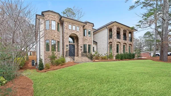 a front view of a house with a yard