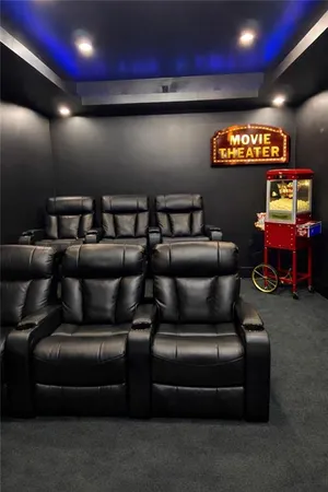 a media room with lots of chairs and a projector