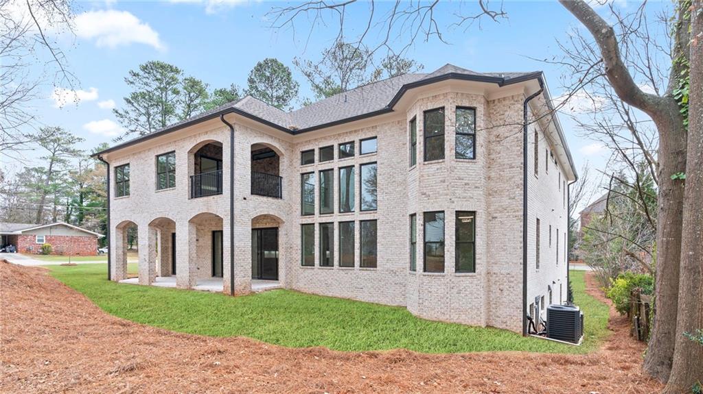 1694 Harts Mill Road Northeast Brookhaven, GA 30319 - Photo 38 of 44 a front view of a house with a garden