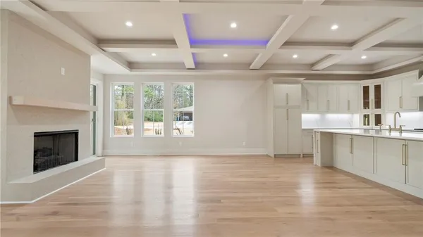 a large kitchen with stainless steel appliances a large counter top a stove and a refrigerator