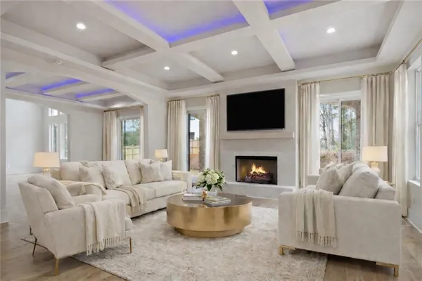 a living room with furniture a fireplace and a flat screen tv