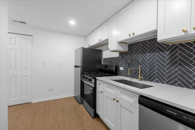 a kitchen with a sink and a stove top oven