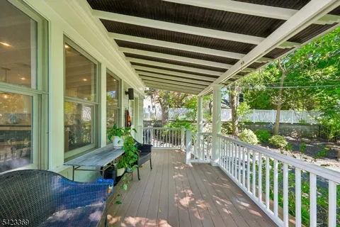 a view of a patio with a table and chairs and potted plants