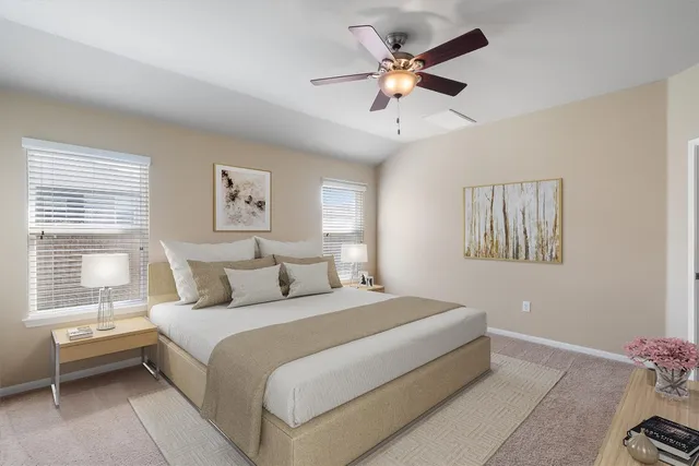 a spacious bedroom with a bed and a window