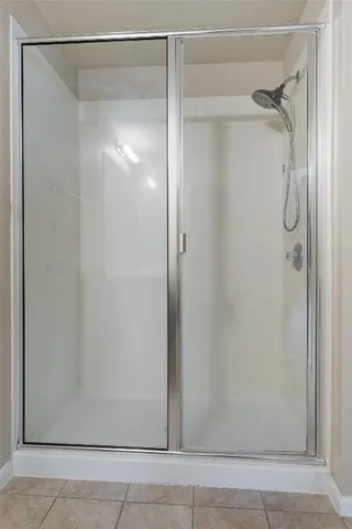 a bathroom with a glass shower door