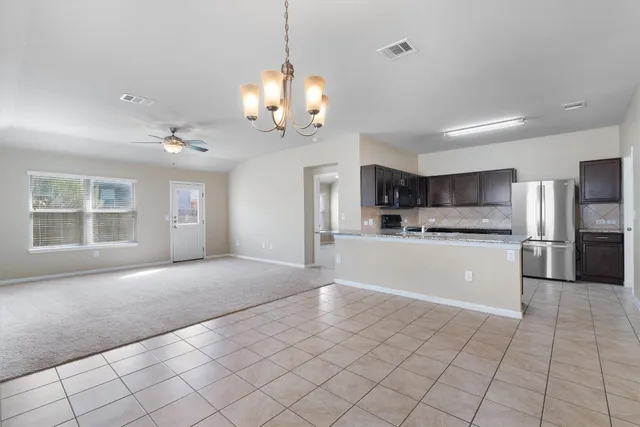 a view of a kitchen with a sink and a stove top oven