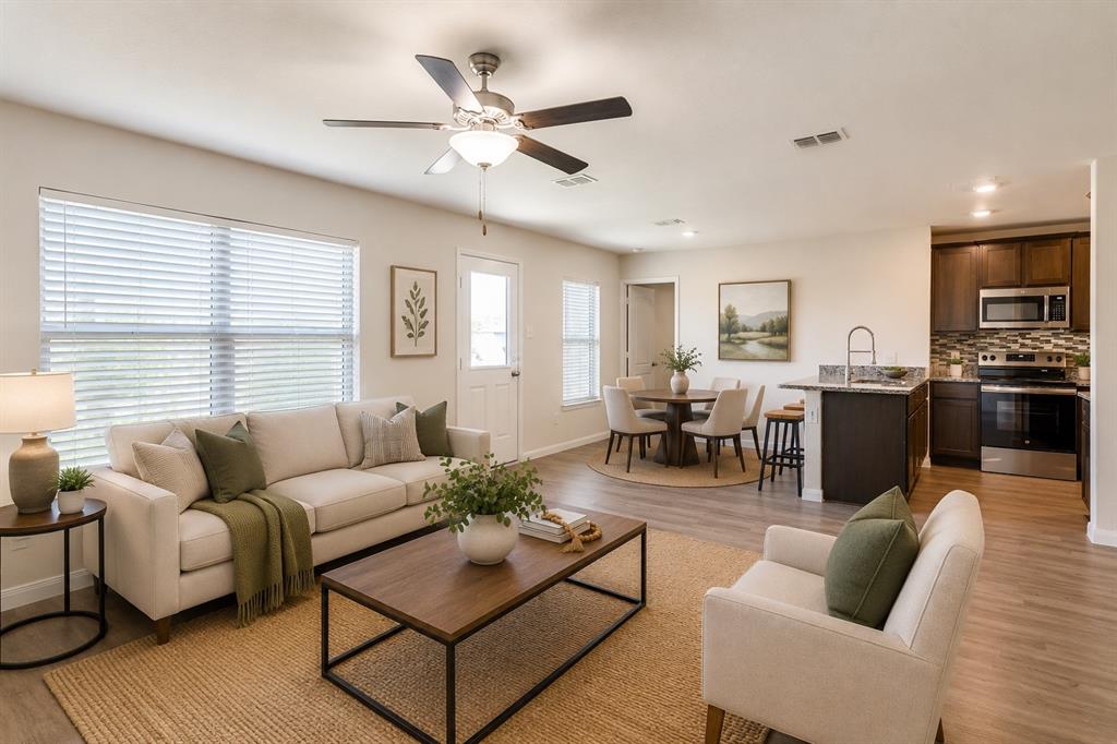 144 Barbwire Way Newark, TX 76071 - Photo 5 of 32 a living room with furniture kitchen view and a large window