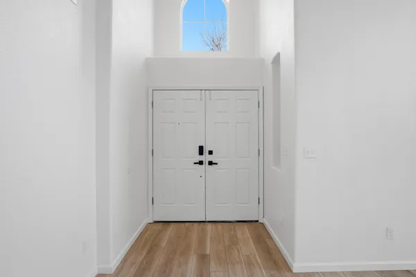 a view of a hallway with wooden floor