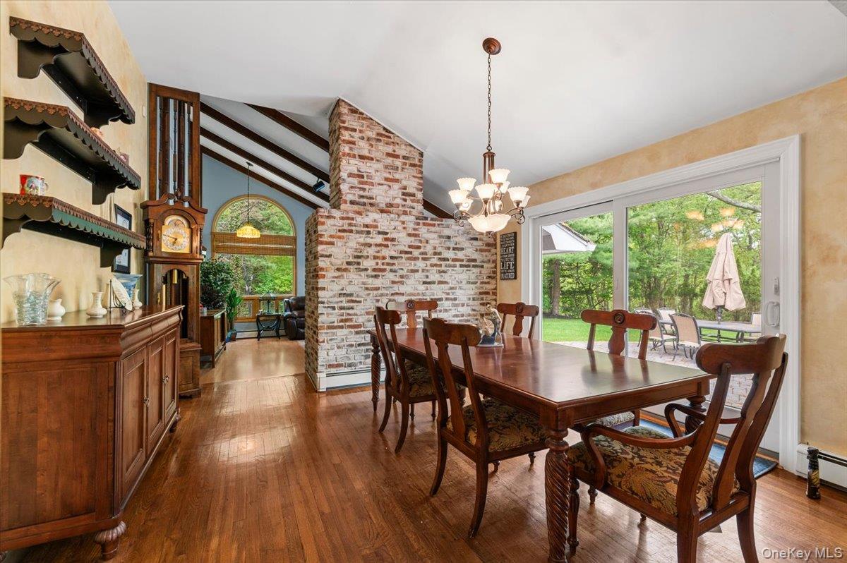 6 Apex Road Melville, NY 11747 - Photo 7 of 50 a view of a dining room and livingroom with furniture wooden floor a chandelier