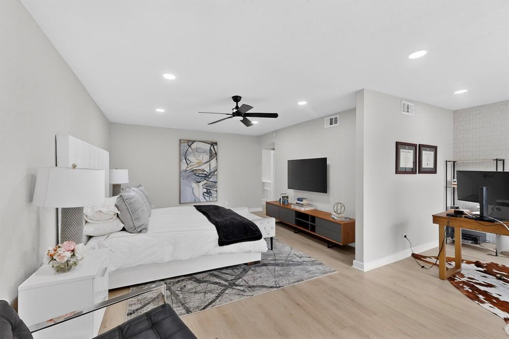 5015 Thunder Road Dallas, TX 75244 - Photo 12 of 31 a bedroom with a bed and a flat screen tv